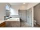Modern bathroom with a large shower, garden tub, and window at 803 Parsons Pointe St, Seffner, FL 33584