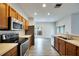 Modern kitchen with stainless steel appliances and wood cabinets at 803 Parsons Pointe St, Seffner, FL 33584