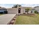 Well-maintained house with a walkway, landscaping, and a two-car garage at 803 Parsons Pointe St, Seffner, FL 33584
