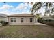 Home's backyard features a spacious grassy area and a patio at 803 Parsons Pointe St, Seffner, FL 33584