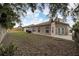 Large backyard with patio, grassy area, and wooden fence at 803 Parsons Pointe St, Seffner, FL 33584