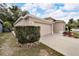 One-story house with a two-car garage and neatly trimmed hedges at 803 Parsons Pointe St, Seffner, FL 33584