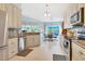 Bright kitchen featuring granite countertops and stainless steel appliances at 2128 W Del Webb Blvd, Sun City Center, FL 33573