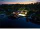Lakefront property with a volleyball court and outdoor lighting at 17501 Brown Rd, Odessa, FL 33556