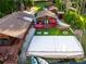 Aerial view of a lakefront property with multiple cabins and a volleyball court at 17501 Brown Rd, Odessa, FL 33556