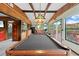 Relaxing game room featuring a pool table and access to a waterfront deck at 17501 Brown Rd, Odessa, FL 33556