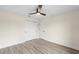 Simple bedroom with ceiling fan and wood-look flooring at 9187 Prospect Ave, Englewood, FL 34224