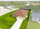 Aerial view of a house with a large yard and a driveway at 9187 Prospect Ave, Englewood, FL 34224