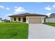 A house with a two-car garage and a well-maintained lawn at 9187 Prospect Ave, Englewood, FL 34224