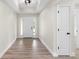 Bright foyer with wood-look tile floors and neutral walls at 9187 Prospect Ave, Englewood, FL 34224