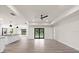 Open living room with wood-look floors, leading to the kitchen and pool at 9187 Prospect Ave, Englewood, FL 34224