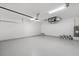 Spacious garage with epoxy flooring and overhead storage at 9187 Prospect Ave, Englewood, FL 34224