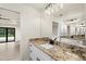 Bathroom with granite countertop, double vanity, and modern fixtures at 9187 Prospect Ave, Englewood, FL 34224