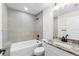 Bathroom with tub, granite countertop, and modern vanity at 9187 Prospect Ave, Englewood, FL 34224