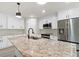 Modern kitchen with stainless steel appliances and granite countertops at 9187 Prospect Ave, Englewood, FL 34224