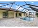 Inviting screened-in pool and patio area with paver stones at 9187 Prospect Ave, Englewood, FL 34224