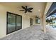 Covered patio overlooking the pool, with paver stones and ceiling fans at 9187 Prospect Ave, Englewood, FL 34224