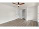 Bright bedroom with wood-look floors, ceiling fan, and spacious closet at 9187 Prospect Ave, Englewood, FL 34224