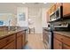 Modern kitchen with stainless steel appliances and granite countertops at 8403 Grand Estuary Trl # 106, Bradenton, FL 34212