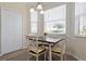 Charming dining area with wood table and window seating at 8403 Grand Estuary Trl # 106, Bradenton, FL 34212