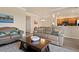 Living room with two sofas, a large TV and access to kitchen at 8403 Grand Estuary Trl # 106, Bradenton, FL 34212