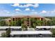Condo building with covered parking and tropical landscaping at 8403 Grand Estuary Trl # 106, Bradenton, FL 34212