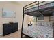 Guest bedroom with a bunk bed and dresser at 8403 Grand Estuary Trl # 106, Bradenton, FL 34212