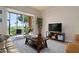 Relaxing living room with patio access, neutral decor, and comfy furniture at 8403 Grand Estuary Trl # 106, Bradenton, FL 34212