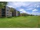 Exterior view of the condo building and golf course at 8403 Grand Estuary Trl # 106, Bradenton, FL 34212
