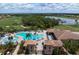 Community clubhouse and pool with lush landscaping at 8403 Grand Estuary Trl # 106, Bradenton, FL 34212