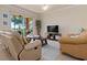 Living room with light walls, comfy seating, and large TV at 8403 Grand Estuary Trl # 106, Bradenton, FL 34212