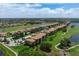Aerial view of condo community near golf course and lake at 8403 Grand Estuary Trl # 106, Bradenton, FL 34212