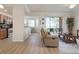 Open concept living area with kitchen, patio access, and neutral decor at 8403 Grand Estuary Trl # 106, Bradenton, FL 34212