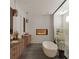 Modern bathroom featuring a fireplace, freestanding tub, and dual vanities at 4305 W Zelar St, Tampa, FL 33629