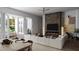 Living area with white sectional sofa, fireplace, and view of backyard patio at 4305 W Zelar St, Tampa, FL 33629