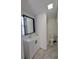Compact bathroom with a single vanity, framed mirror, toilet, and shower at 4305 E Deleuil Ave, Tampa, FL 33610