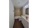 Bathroom features a tub and shower, vanity, and neutral tile at 4305 E Deleuil Ave, Tampa, FL 33610