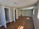Sunlit bedroom showcasing wood floors, neutral walls, with multiple doors leading to other rooms at 4305 E Deleuil Ave, Tampa, FL 33610