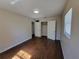 Bedroom with wood-look floors, neutral walls, and a closet at 4305 E Deleuil Ave, Tampa, FL 33610
