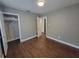 Bedroom with wood-look floors, neutral walls, closet and white trim at 4305 E Deleuil Ave, Tampa, FL 33610
