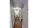 Hallway with wood-look flooring, neutral walls, and white doors at 4305 E Deleuil Ave, Tampa, FL 33610