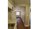 Galley kitchen features white cabinets and granite countertops at 4305 E Deleuil Ave, Tampa, FL 33610