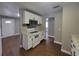 Well-lit kitchen with modern appliances, white cabinets, and wood-look floors at 4305 E Deleuil Ave, Tampa, FL 33610