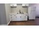 Bright kitchen with double sink, granite countertops and white cabinets at 4305 E Deleuil Ave, Tampa, FL 33610
