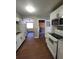 Updated kitchen with white cabinets, granite countertops, and modern appliances at 4305 E Deleuil Ave, Tampa, FL 33610