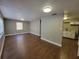 Spacious living room with new hardwood flooring, modern paint and a partial view of the kitchen at 4305 E Deleuil Ave, Tampa, FL 33610