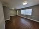 Spacious living room featuring wood floors, neutral paint, and a window at 4305 E Deleuil Ave, Tampa, FL 33610