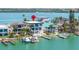 Waterfront home featuring a backyard pool, boat dock, and stunning water views, perfect for outdoor living at 831 Bay Point Dr, Madeira Beach, FL 33708