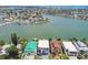 Aerial view of waterfront property showing proximity to open water and neighborhood at 831 Bay Point Dr, Madeira Beach, FL 33708