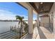 Spacious balcony with stunning water views and a dark wood plank ceiling at 831 Bay Point Dr, Madeira Beach, FL 33708